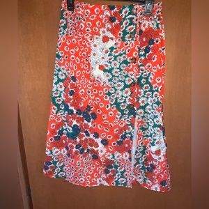 Women’s midi skirt. A orange/coral with teal, beige, and white accents.